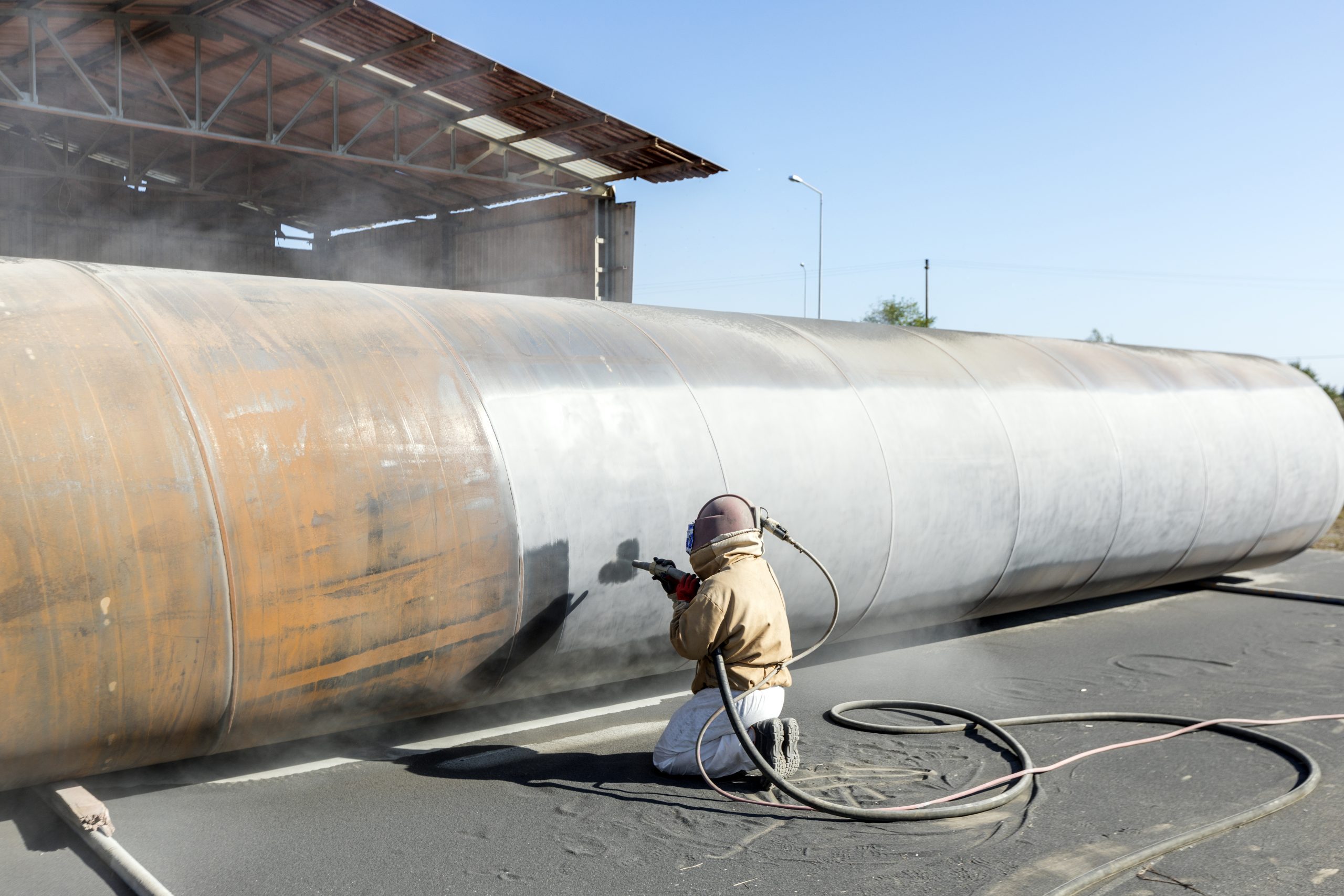 Abrasive blasting more commonly known as sandblasting is the operation of forcibly propelling a stream of abrasive material against a surface under high pressure.